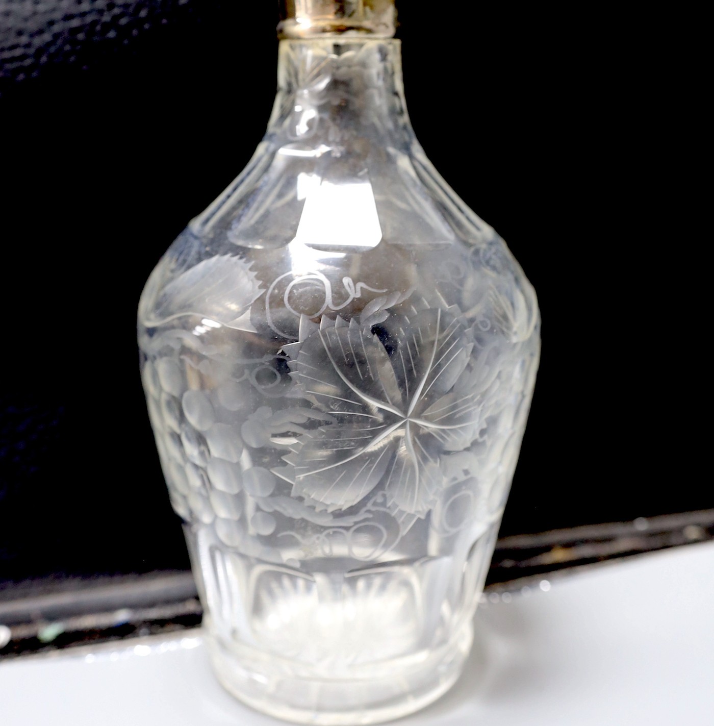 A silver plated wine cooler, a silver topped decanter and a silver lidded cut glass biscuit barrel